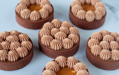 Obraz na płótnie Canvas Creamy tarts with caramel and nuts