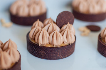 Chocolate tart with caramel and nuts and creamy picks ontop