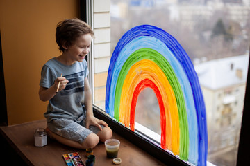 let's all be well. child at home draws a rainbow on the window. Flash mob society community on self-isolation quarantine pandemic coronavirus. Children create artist paints creativity vacation