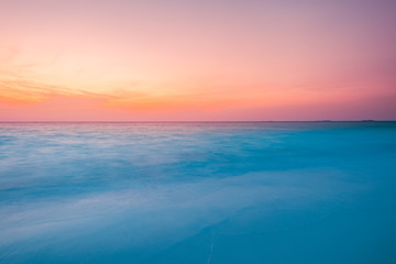 Naklejka premium Peaceful tropical sunset beach with bokeh sun light wave abstract background. Copy space of outdoor summer vacation and travel adventure concept. Vintage tone filter color style.