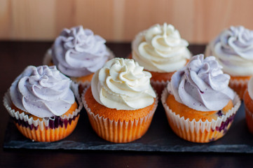 Colorful cupcakes with caramel inside and cream ontop