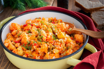 Vegetable stew with cauliflower in an enamel pan, selective focus