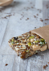 Superfood breakfast homemade bars with oats and seeds, on white wooden background