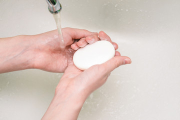 Soap in the hands. Hand washing with soap. The use of antibacterial agents for the body and hands....