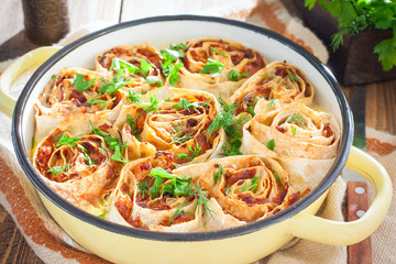 Cabbage pie in a round pan, selective focus