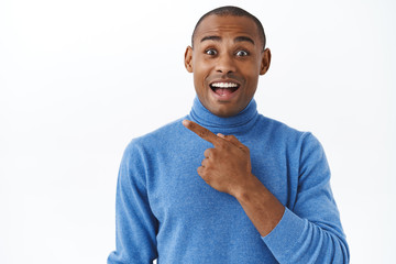 Have you seen it, awesome. Portrait of enthusiastic happy african-american man recommend to...