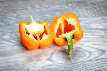 Orange Pepper sliced in half showing the inner seeds