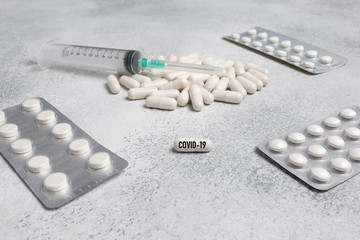 Medical syringe, medicine pills, capsules on concrete background. prescription drug for treatment...