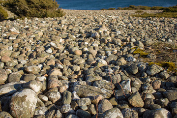 Stones near the water and the blue sky