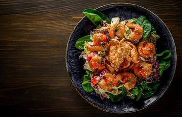 Fresh salad plate with shrimp, tomato, spinach, cabbage and Tangerine Jam in plate on wooden table background