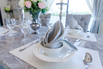 Dishes and the silverware on the dining table 