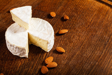 Camembert cheese or brie on wood background