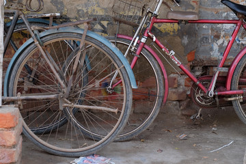 Fototapeta na wymiar Bicycle leaning on wall in Kumrokhali, West Bengal, India
