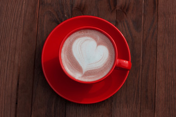 Red cup of cacao on wooden background
