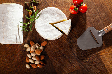 Camembert cheese or brie on wood background