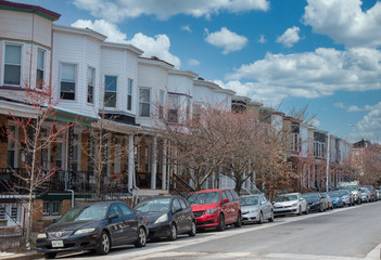 Baltimore typical row houses with porches on a sunny day