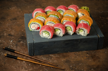 Roll sushi with salmon, cucumber, avocado, cream cheese, red caviar. Sushi menu. Japanese food.