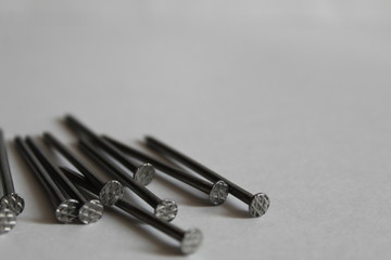 Fototapeta premium a pile of long nails lies on a white background