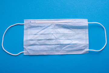Protective medical face mask on a blue background