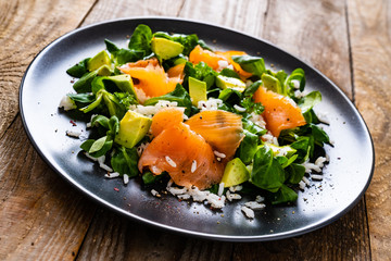 Salmon salad - smoked salmon white rice and vegetables on wooden table
