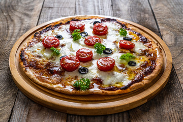 Margherita pizza on wooden background