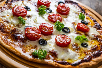 Margherita pizza on wooden background