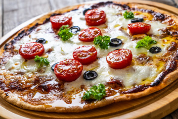 Margherita pizza on wooden background