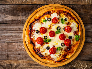 Margherita pizza on wooden background