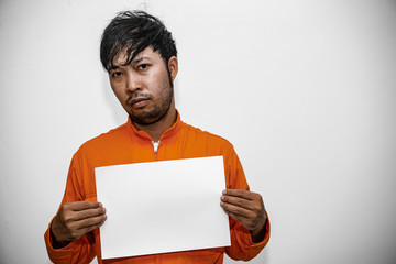 Prisoner in orange robe concept,Portrait of asian handsome man in Prison uniforms,Bandit has a lot...