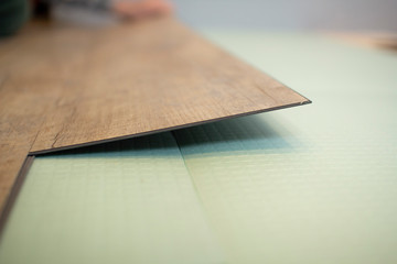Fototapeta na wymiar Vinyl laminate. Laying of the floor covering.