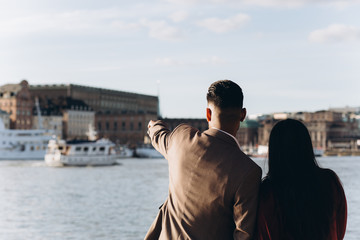 Loving happy couple hugging outdoors in city streets together. Dating and romance time for loving people