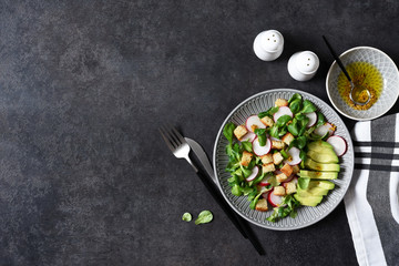 Corn salad with radish, crackers and honey and mustard sauce. View from above.