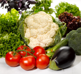 raw and fresh tomato eggplant cauliflower on the kitchen table