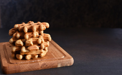 Cheese waffles with corn salad and tomans - healthy breakfast on a concrete background.