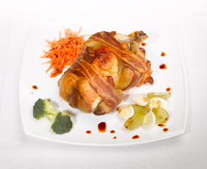 pork knuckle with eggs and herbs on a white plate on the table