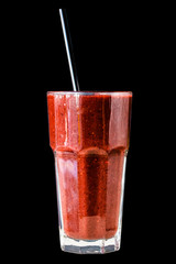 Red berry smoothie in a large glass glass on a black background, isolated