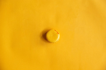 Top view of tasty crack  orange yellow macarons.