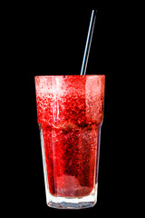 Red berry smoothie in a large glass glass on a black background, isolated