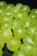 green grape berries on a black table