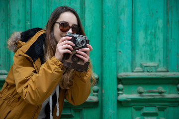 Photo of young tourist girl exploring streets of Baku. Moody photos of teenager girl visiting old city and taking photos of the city