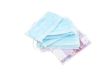 A pack of medical mask lies on 500 euro banknotes. The concept of buying a mask in Europe for a lot of money, virus protection, lack of protection. Isolated white background...