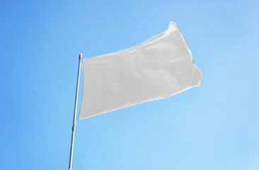 White flag with clear sky in background. Flag mockup