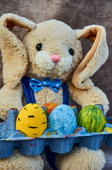 toy bunny with easter hand-painted eggs