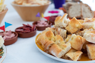 Italian pizza bread chopped for party finger food. Salami, prosciutto and mortadella, italian food birthday party.  Pizza bianca