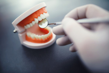 Dentist's office. Dentist examines the oral cavity before treatment. The doctor shows a course of...