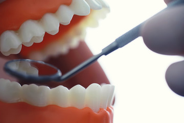 Dentist's office. Dentist examines the oral cavity before treatment. The doctor shows a course of treatment. Caries jaw treatment. Implantation and installation of veneers.