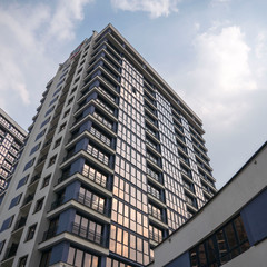 building facade reflection in glasses against the sky