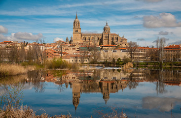 Fototapeta na wymiar View of Salamanca and its Cathedral, reflected in the calm waters of the Tormes river. Spain