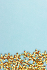 small gold confetti stars on a blue background
