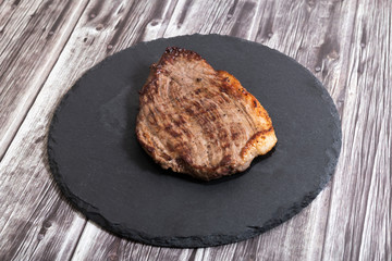 Grilled beef steak ribeye on dark wooden background top view